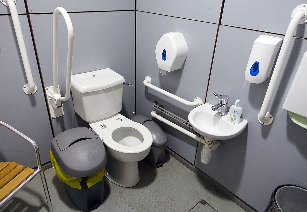 A white toilet with the tank (UK: cistern) mounted above the bowl