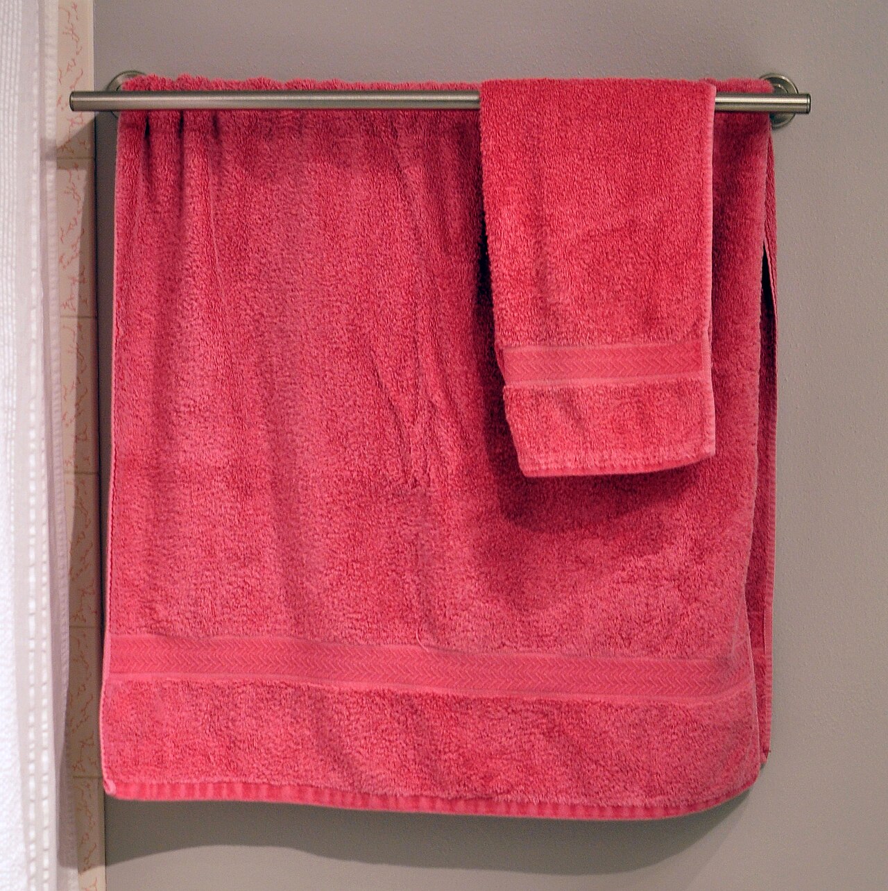 Towels hanging on a wall-mounted towel bar