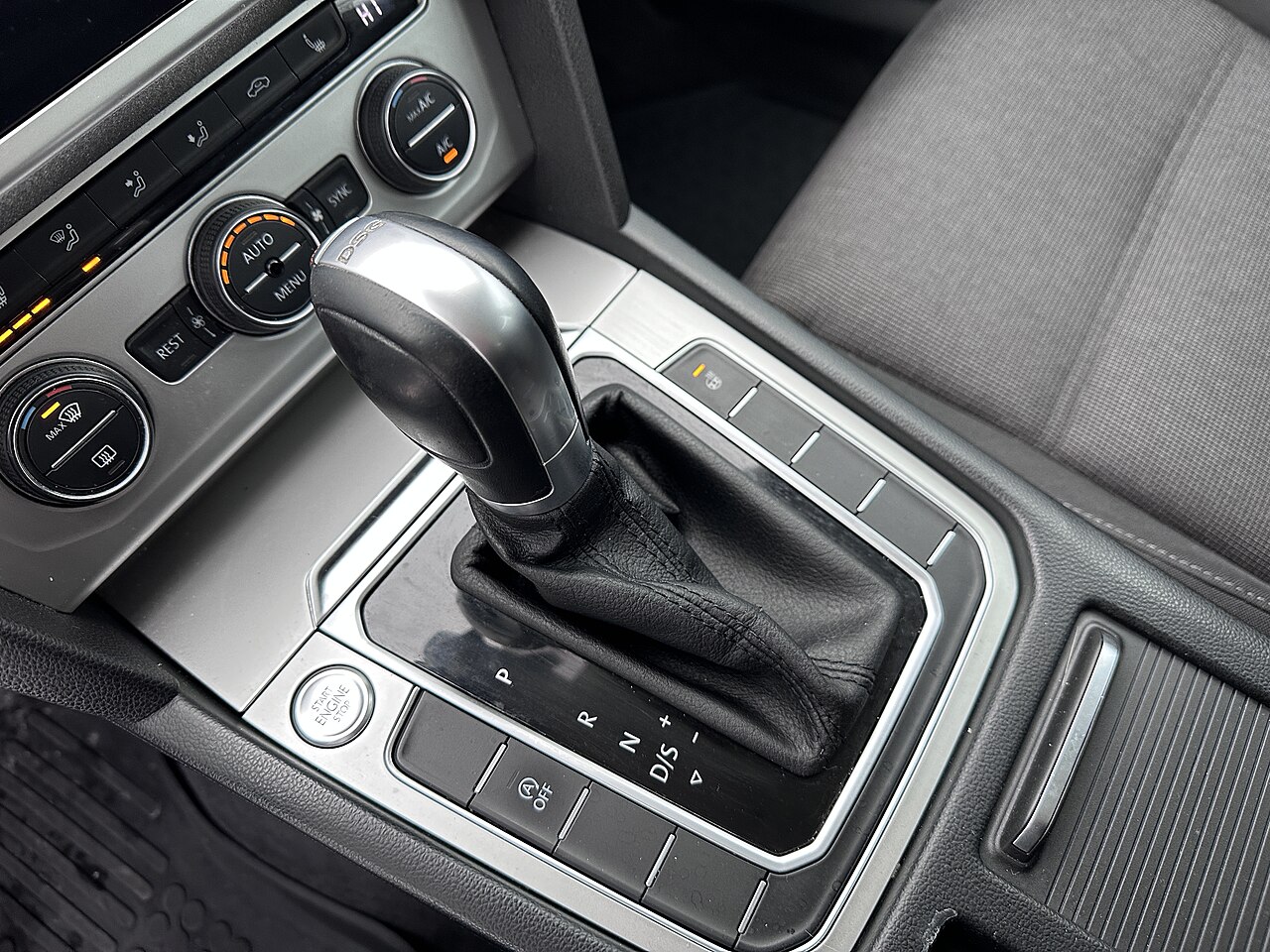 The center console of a car, showing the gearshift and the surrounding controls