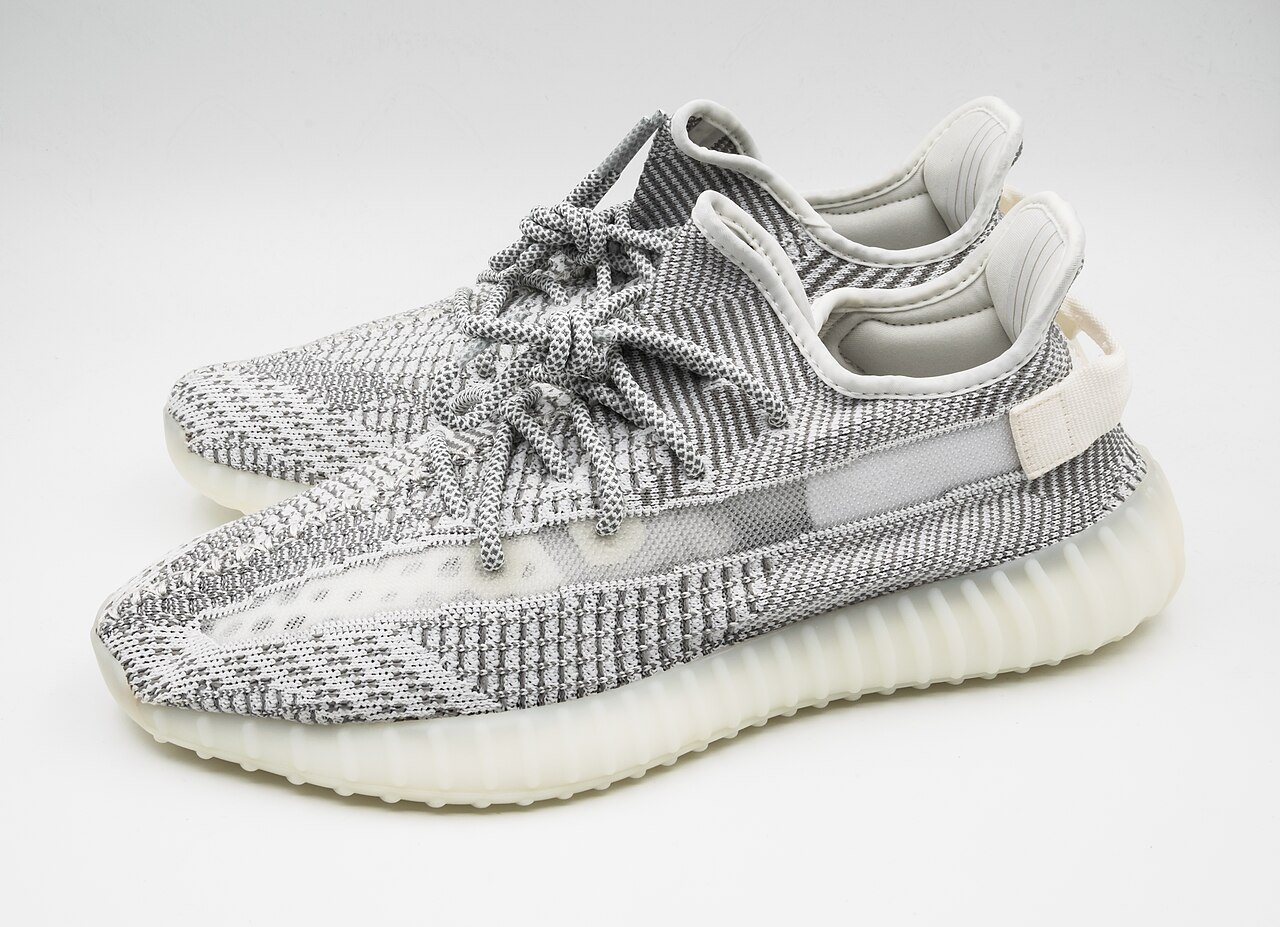 A clean pair of grey and white sneakers