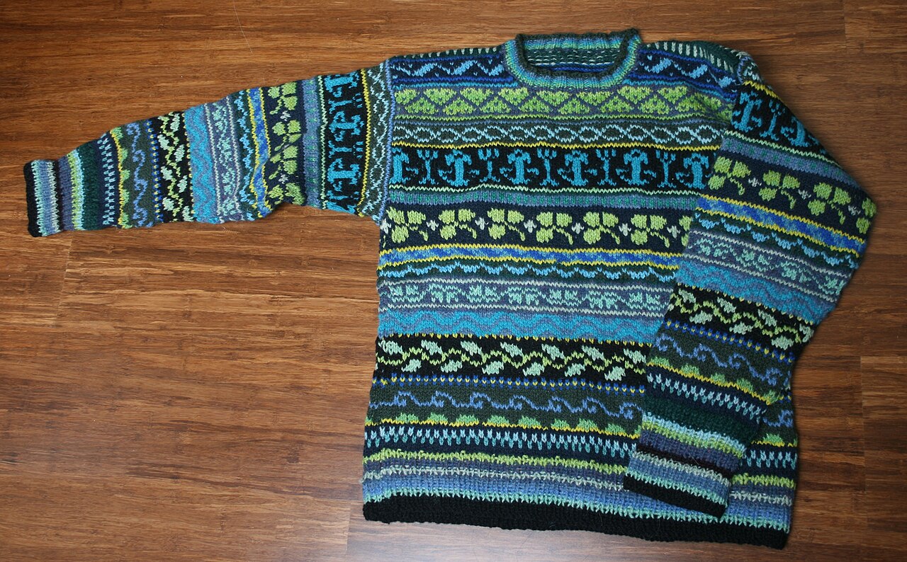 A colorful hand-knitted Fair Isle sweater laid flat