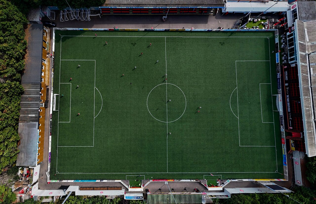 Aerial view of a soccer field showing the white markings, including the halfway line, center circle and penalty areas