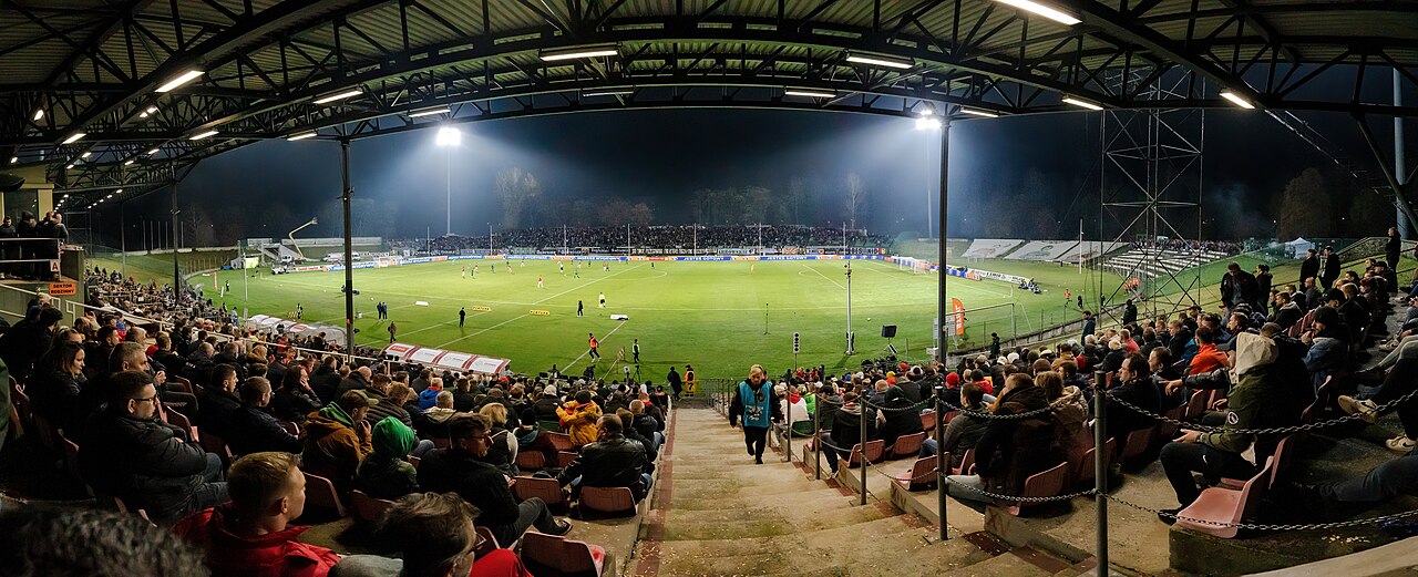Spectators filling the stands around a soccer field on a match day