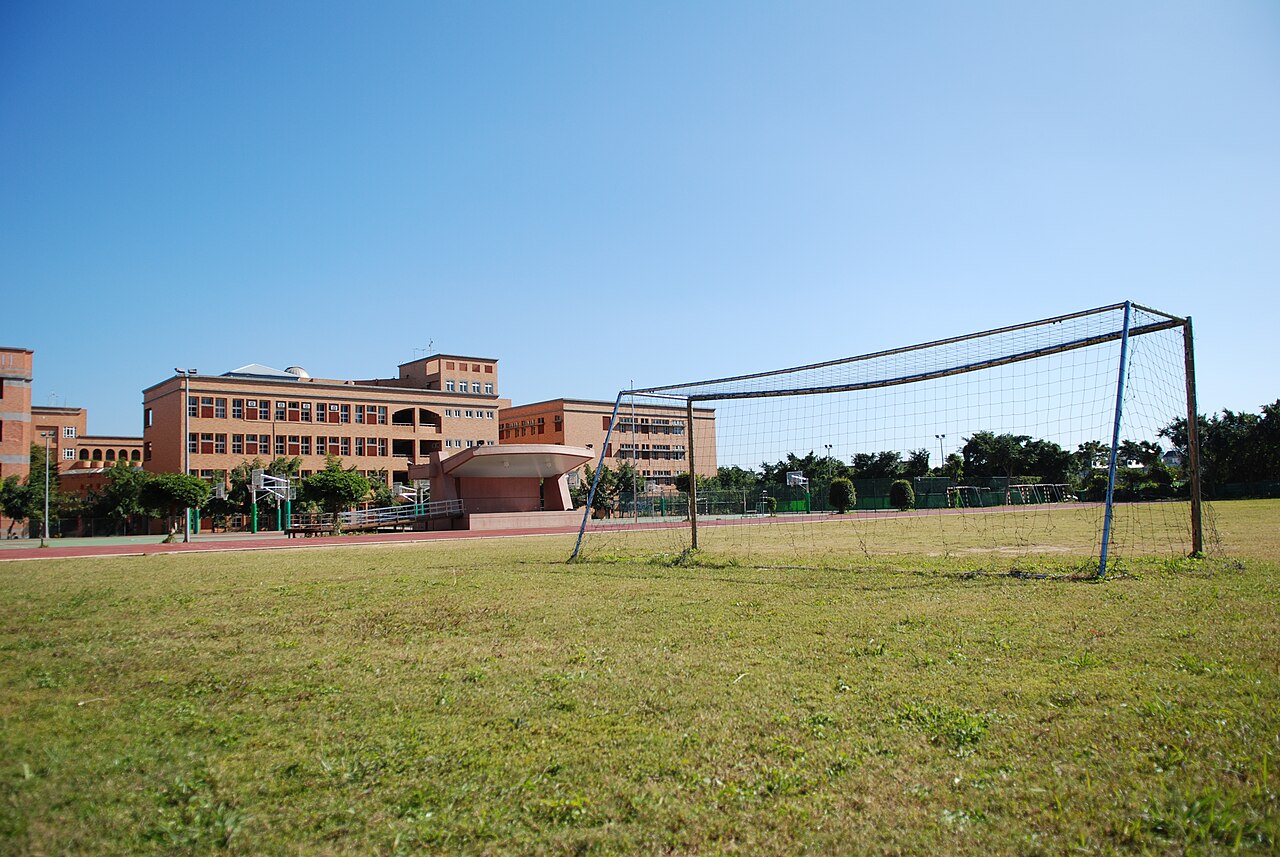 A full-size soccer goal on a grass field, showing the two goalposts, the crossbar and the net