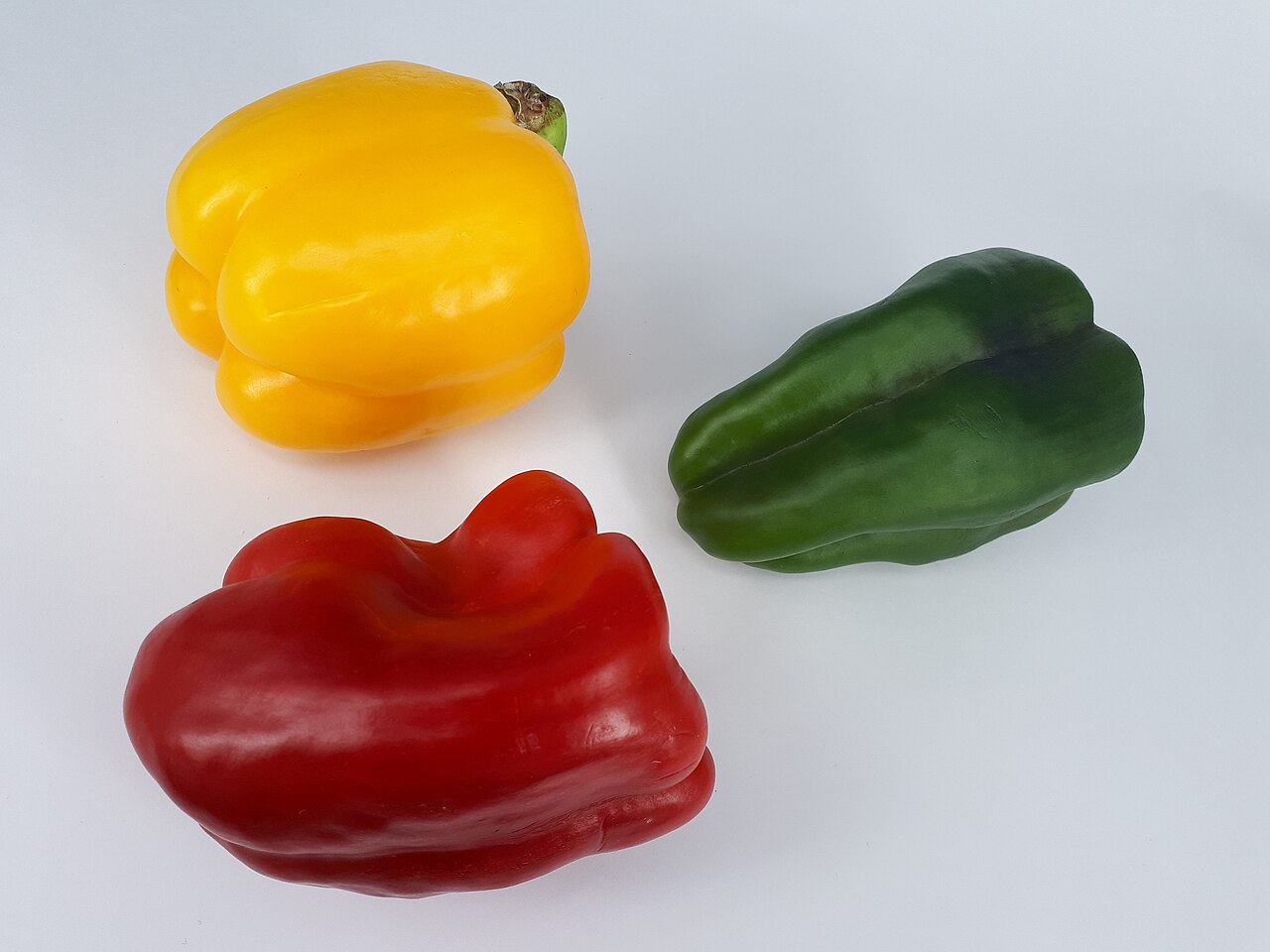 Three bell peppers: one yellow, one green, one red