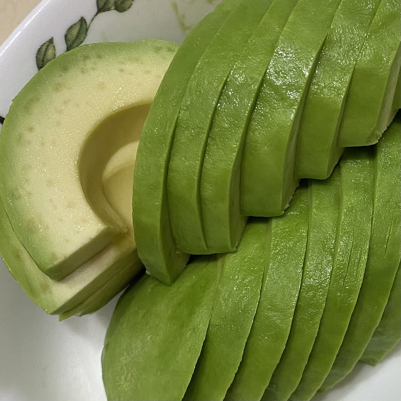 A ripe avocado sliced open, showing the round pit cavity