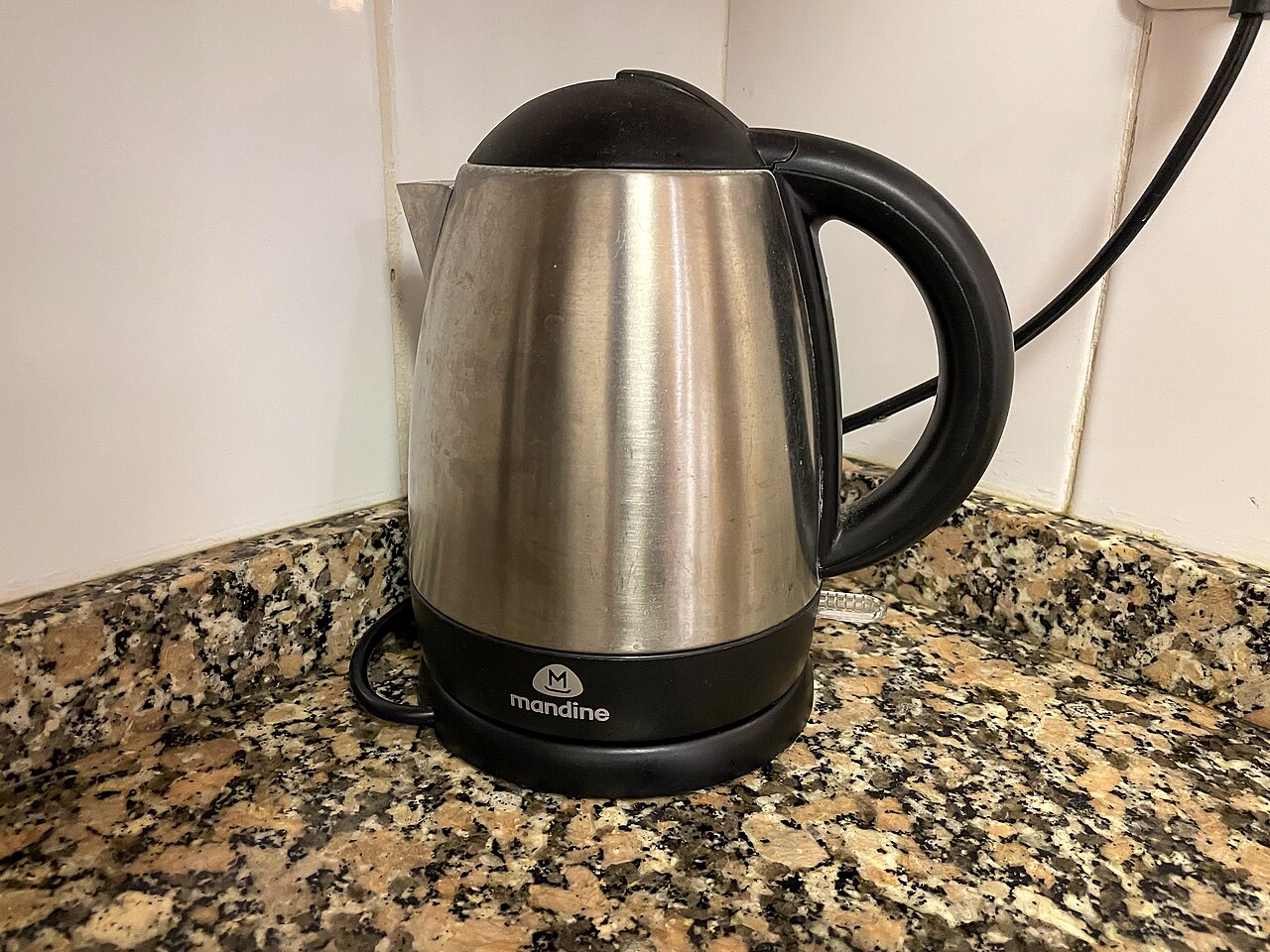 An electric kettle on a kitchen countertop, used to boil water