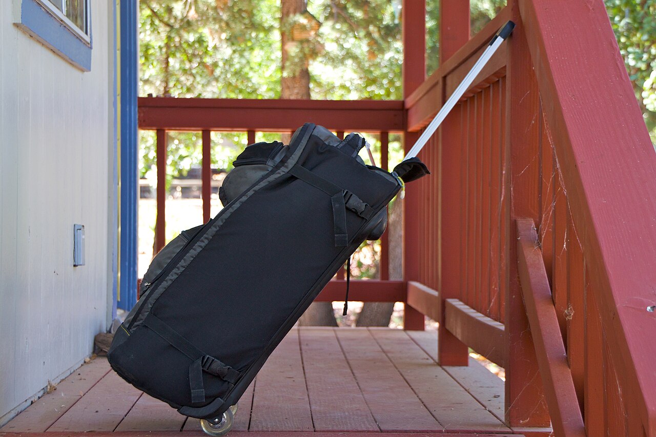 A packed rolling suitcase ready by the door
